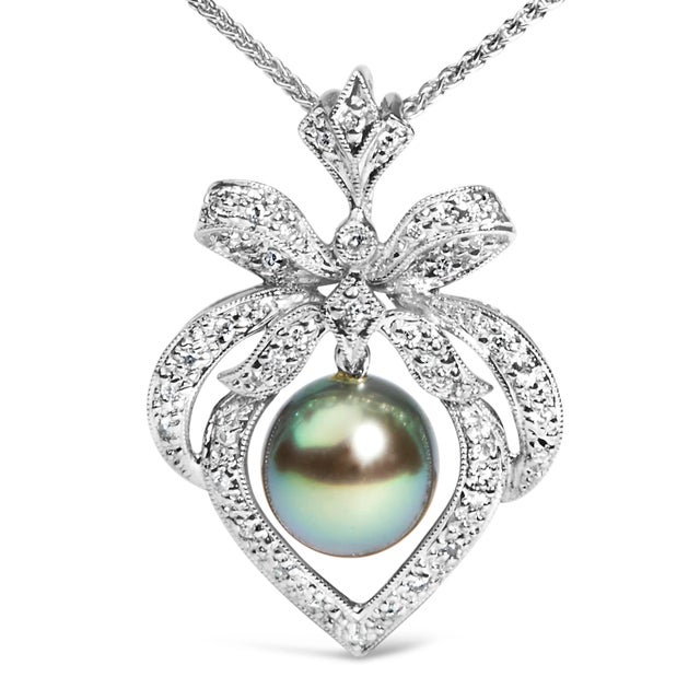 Indulge in the timeless elegance of this exquisite pendant necklace, where the radiance of 18K white gold, enhanced by a...