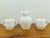 Elevate your home decor or coffee service with this classic three-piece collection of vintage Fenton milk glass in the...