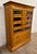 This is a stunning and rare vintage wood Haberdashery, Haberdasher, or apothecary cabinet with glass fronted drawers and...