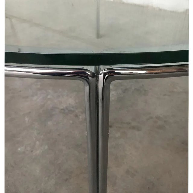 Round Mid Century glass table with chrome frame. The heavy chrome frame made of flat steel looks very restrained and...