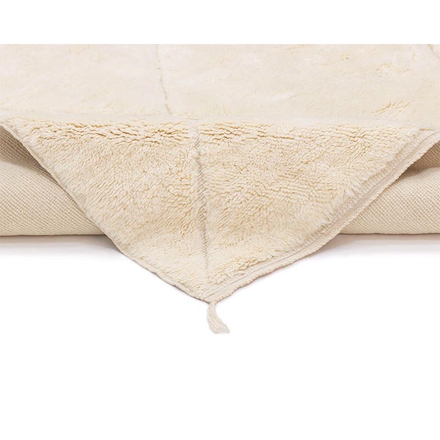 Elegant hand-knotted wool rug in Ivory, adorned with subtle asymmetrical diamond patterns, offering a chic and versatile...