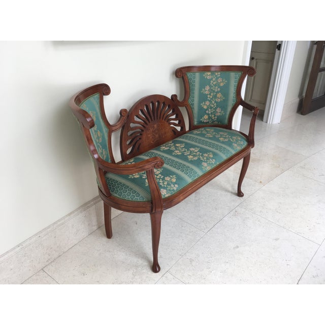 Elegant French settee featuring ornate inlay wood design and fine upholstery. Perfect for an entry way.