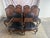 An elegant set of eight French Provincial-style dining chairs, including six side chairs and two armchairs, crafted with...