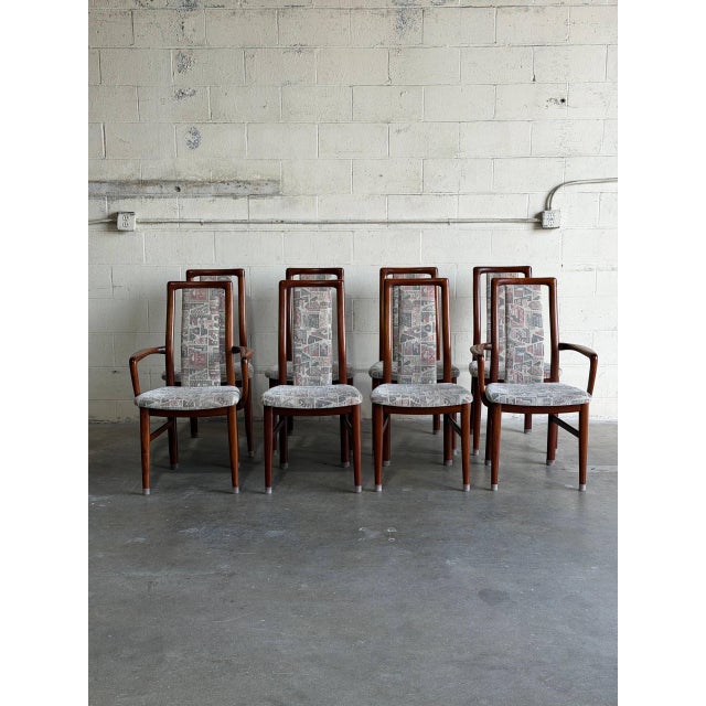 This dining set features organic curved high backrests integrated into a geometric frame. The design balances sleek...