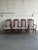 This dining set features organic curved high backrests integrated into a geometric frame. The design balances sleek...