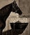 A finely executed antique equestrian study depicting a sleek thoroughbred standing in profile within a stable interior....