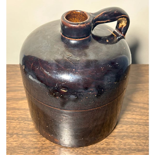 Up for sale is a Late 19th Century American Primitive Albany Slip Glazed Brown Stoneware Beehive-Form 1/2 Gallon Jug! It...