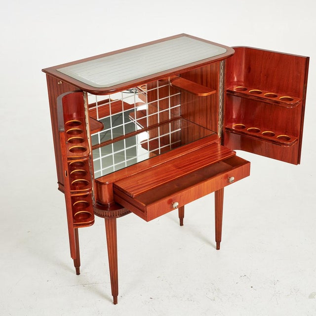 Mid century bar cabinet in excellent condition. Inside original mirrored glass, glass racks on the inside of the doors,...