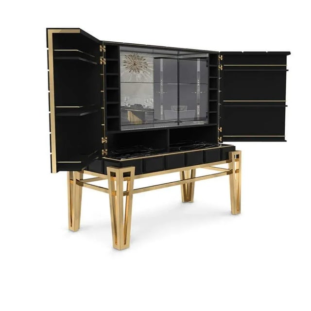 Bar cabinet in brass and wood Measures: Height 61.03 in. (155 cm) Width 45.67 in. (116 cm) Depth 22.84 in. (58 cm)...