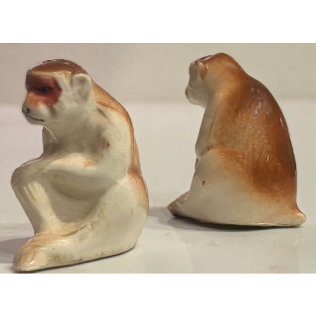 Charming pair of porcelain salt and pepper shakers in the shape of a pair of monkeys. Marked “Made in Occupied Japan”...