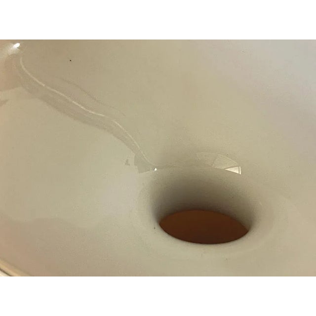 This vase is made in glass in Opaline. It has been made in Italy in the 1970's. It is a beige color. Small default in the...