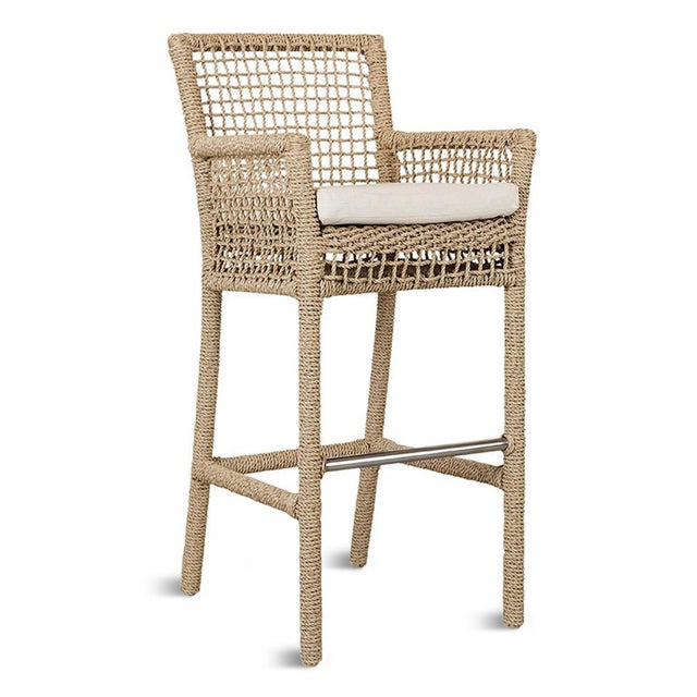 Bring effortless coastal style to your outdoor entertaining space with this handwoven faux hyacinth outdoor bar stool....