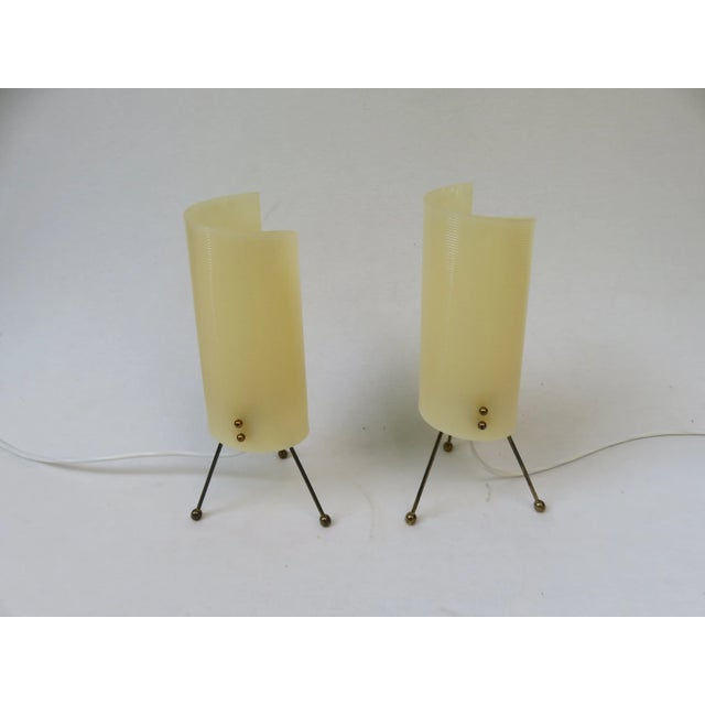 - Pair of night lights from the 1950s - Stands on a brass tripod with ball feet - Screens made of beige Acrylic Glass -...