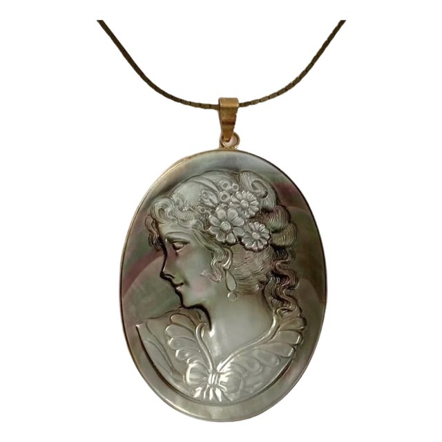 A stunning vintage 14k gold and black mother of pearl carved cameo pendant and 14k gold box chain. This is a spectacular...