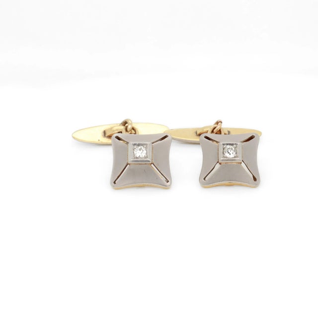 A fine pair of Mid-Century Modern cufflinks. In 18k yellow gold with platinum-topped faces and toggles. Each prong set...