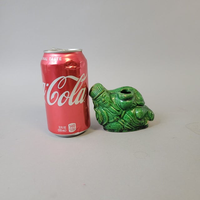 A charming late Qing to early Republic green-glazed water dropper modeled as a reclining Drunken Immortal. Shown resting...