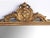 the rectangular mirror plate within a classically-inspired giltwood frame with beaded slip and leaf band outer edge all...