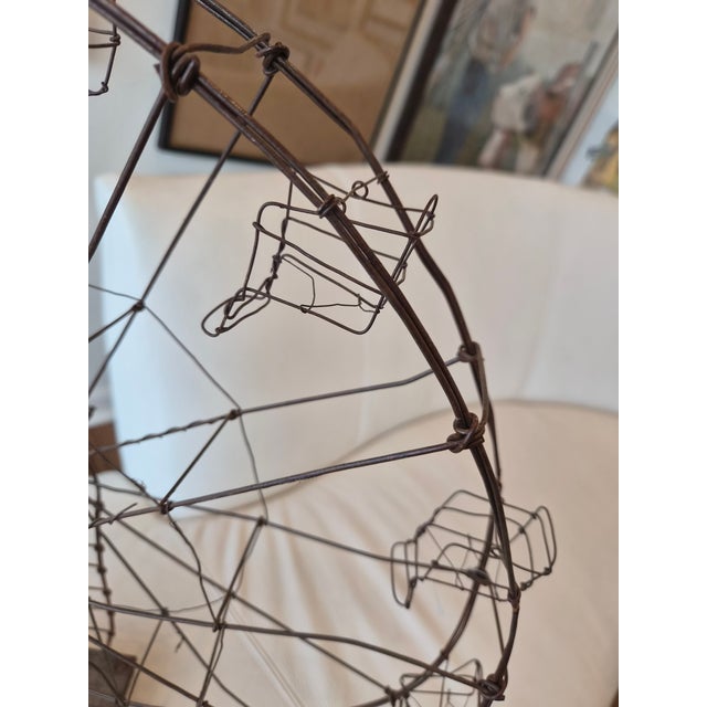This is a hand wired decorative ferris wheel, made in the 1940s. It is mounted on a wooden block. The whole wheel spins...