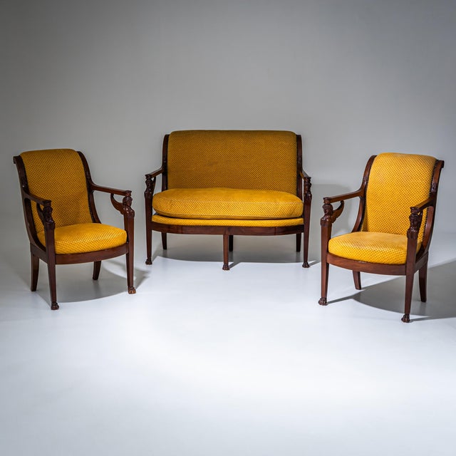 Empire seating suite in mahogany, consisting of a two-seat sofa and four armchairs (two not shown). The frames display a...