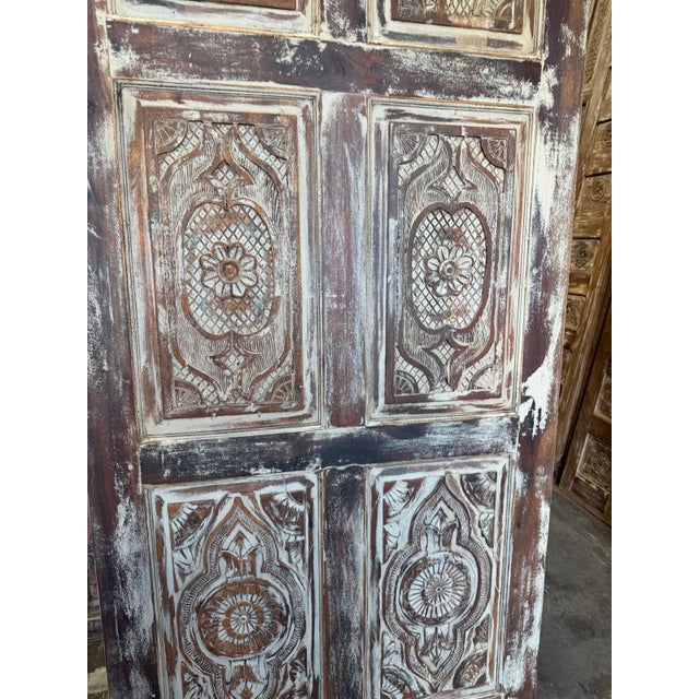 Bring timeless elegance and rustic charm to your space with these floral carved wood sliding barn doors in a beautifully...