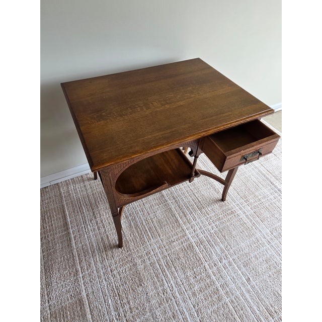 This is an exquisite Art Nouveau oak table with all the curves and design elements one would expect from the period. This...