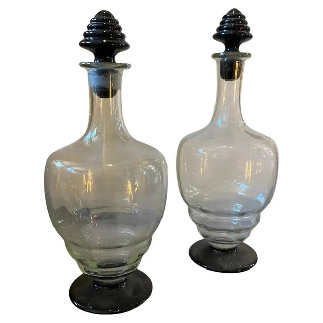 Two transparent and black murano glass liquor bottles manufactured in Italy in the Thirties in the style of Napoleone...