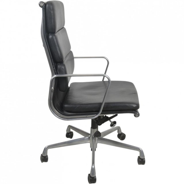 Charles Eames EA219 office chair upholstered in black leather, with a tall backrest and soft pad, and with aluminium...