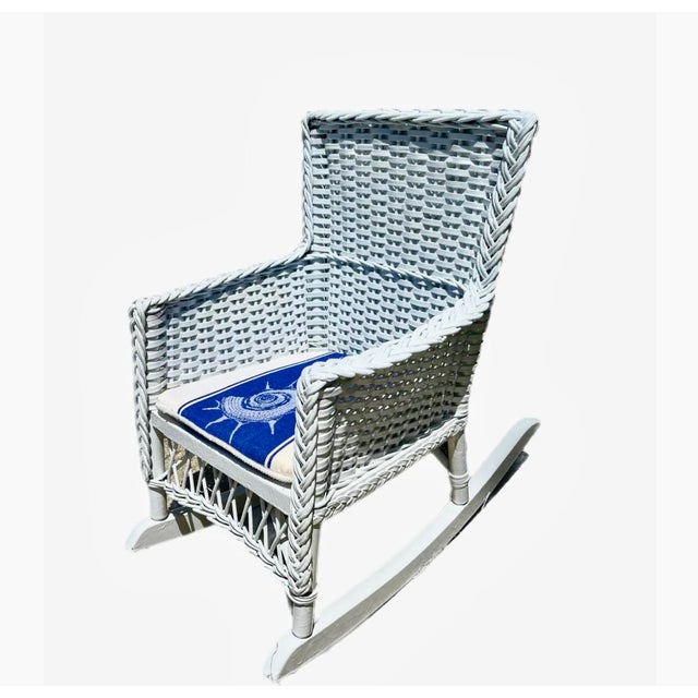 Sweet vintage children's rocking in chair in glossy white. Comes with custom blue and white nautical cushion.