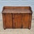 This is an antique primitive wash stand cabinet made of pine wood with a wood gallery and a single door that opens to...