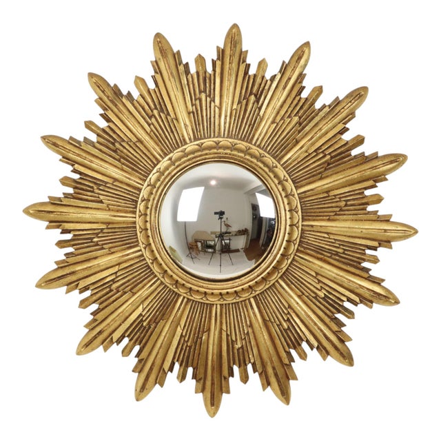 A stunning and very rare vintage sunburst mirror featuring convex glass and layered rays; crafted from resin and finished...