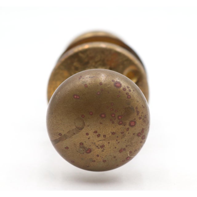 Classic style patina brass passage door knob set with textured design rosette. Priced as two door knobs, two rosettes, and...