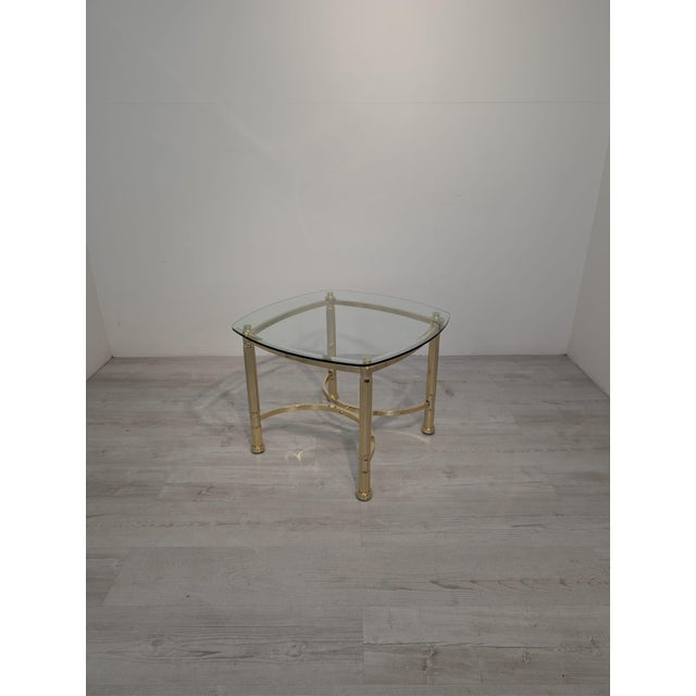 An elegant coffee table in the striking Hollywood Regency style, combining timeless classic style with a luxurious,...