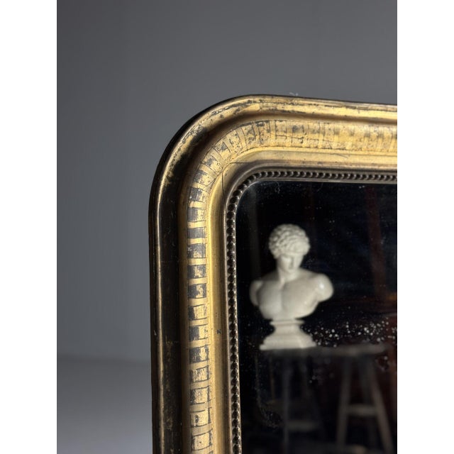 Louis Philippe mirror. Originating from France, 19th century. Gilded frame, beautifully slightly weathered. with original...