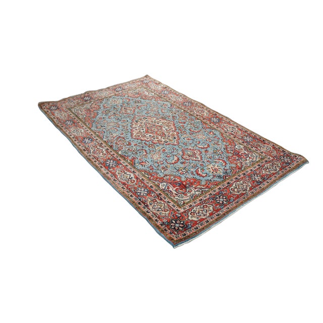 This Handmade Persian rug showcases a classic curvilinear design, featuring a prominent, detailed star medallion centered...