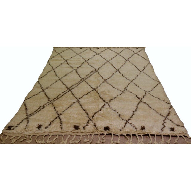 Hand-knotted with care using traditional rug-making techniques, this wool rug blends timeless craftsmanship with a modern...