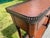 A leather panelled and solid wood console table, decorated throughout with verdigris brass mounts, the galleried top above...
