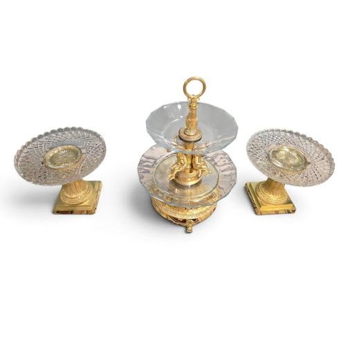 An exceptional and highly refined three-piece French Empire table garniture, comprising a large central centrepiece and a...
