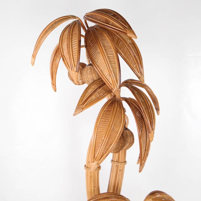 Stunning rattan floor lamp in the shape of a three-trunked coconut palm. Featuring multiple removable fronds and lights...