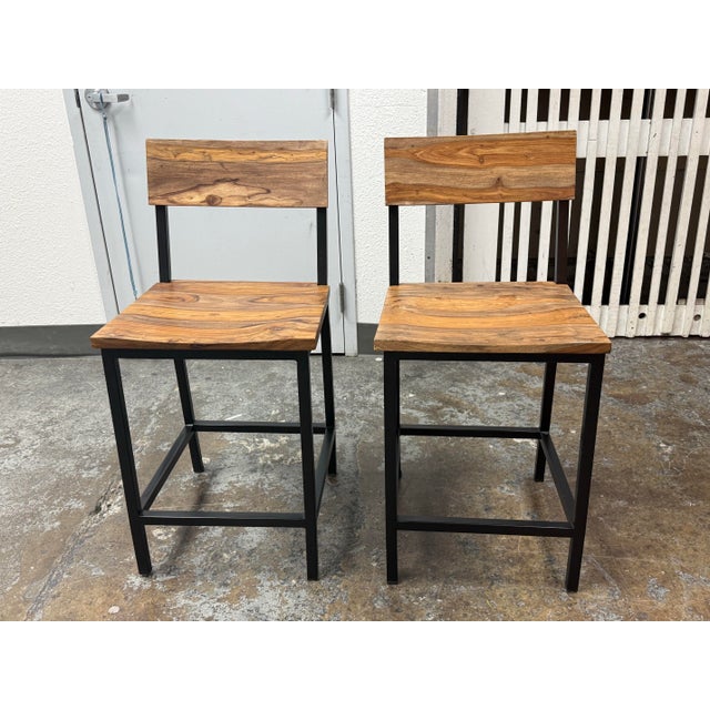 Design Plus Gallery presents a pair of Industrial Acacia Wood + Metal Barstools. Each stool combines a solid acacia wood...