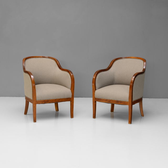 Pair of Swedish art deco club chairs fully restored and upholstered in a muted green fabric. Re-finished. Sweden circa 1930.