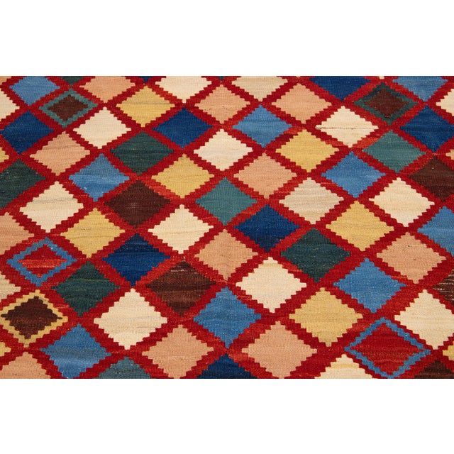 Beautiful Vintage Kilim square hand-knotted wool rug with multicolor accents in an all-over geometric design. This rug...