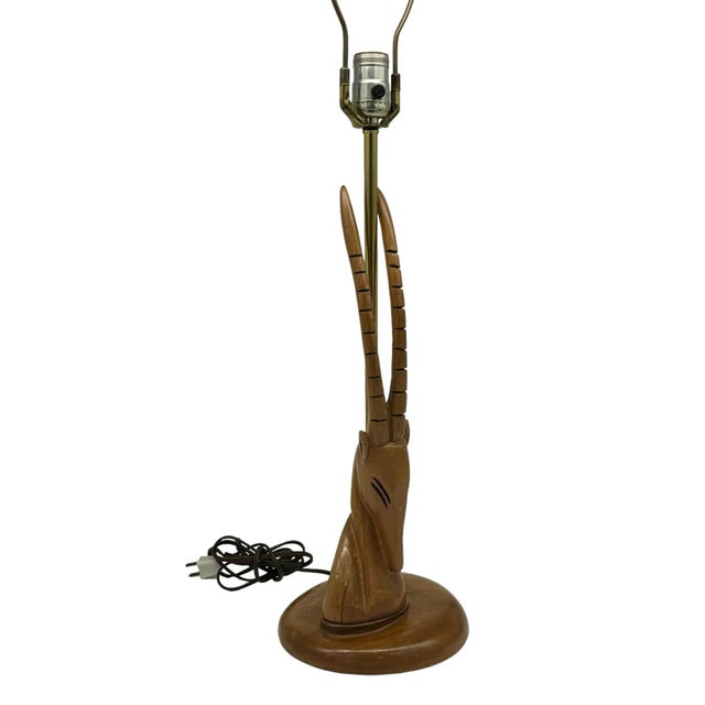 Our sleek vintage MCM gazelle table lamp is beautifully sculpted in fine walnut wood, bringing a touch of nature indoors....