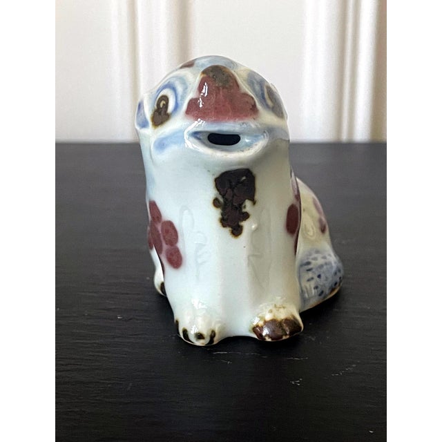 A lovely Korean ceramic water dropper in the form of a sitting dog circa 19th century late Joseon Dynasty. The charming...