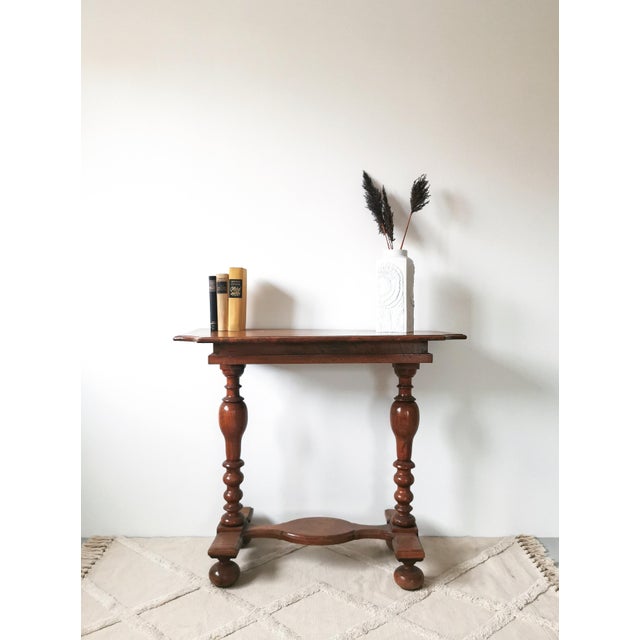 This console table, crafted around 1880 in the Historicist style, is likely made of walnut or chestnut wood and features...
