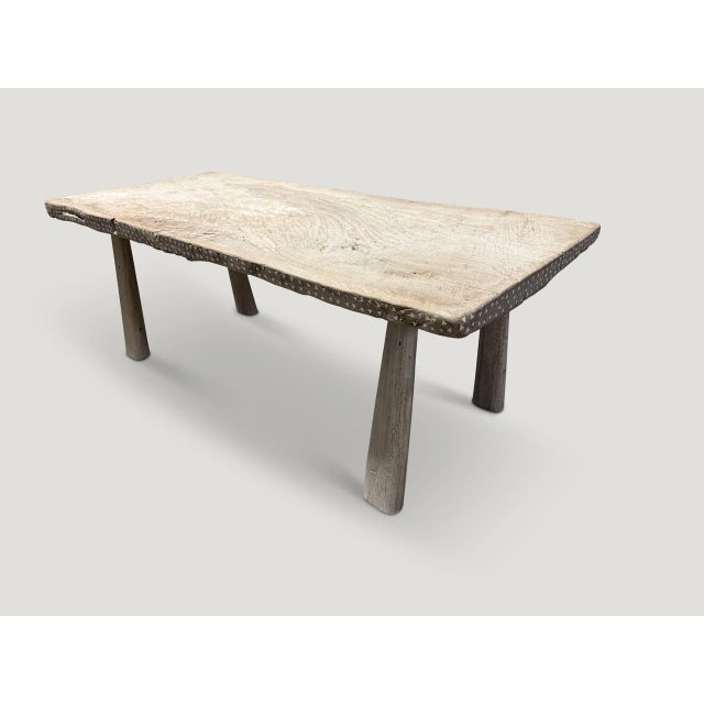 A beautiful century old two inch thick teak slab with a slight live edge, has been hand crafted into a unique coffee table...