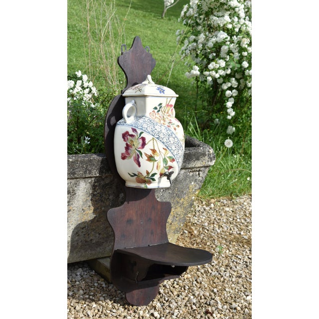 A distinctive and decorative French ceramic wall fountain by Longchamp, crafted in terre de fer and dating to the Art...