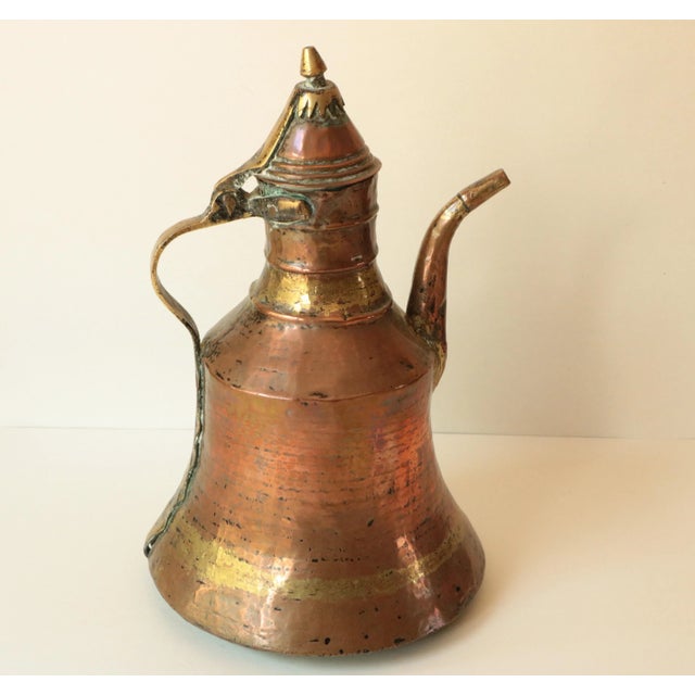 This hand-hammered dallah, or coffee kettle, has timeworn character from its genuine patina of age & use.