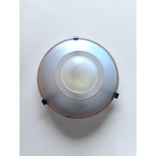 Ceiling or wall lamp produced by f. Fabbian. Postmodern design, the molded glass shade features a circular shape with...