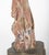 Beautiful carving of Guanyin, shown standing on a rocky outcrop, mounted on a lobed wooden base. It was once used as a...