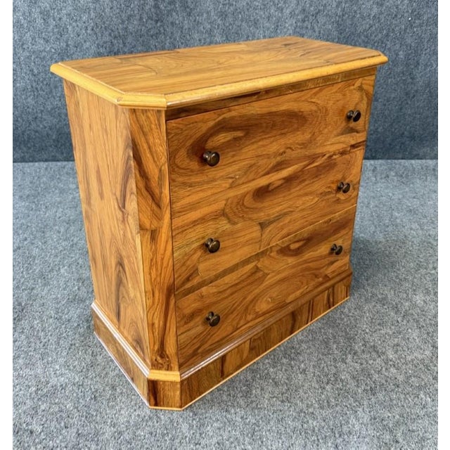 This diminutive 1960s three-drawer chest is crafted from solid elm wood and showcases exceptionally striking, almost...